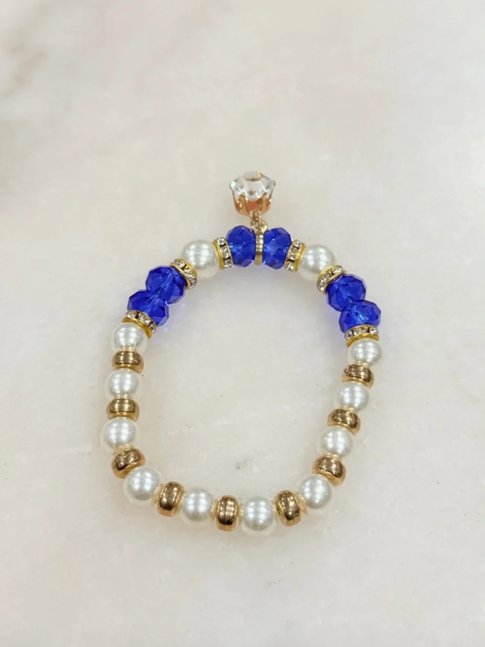 Gold and Pearl Beaded Stretch Bracelet with Blue Crystal Accents and Charm